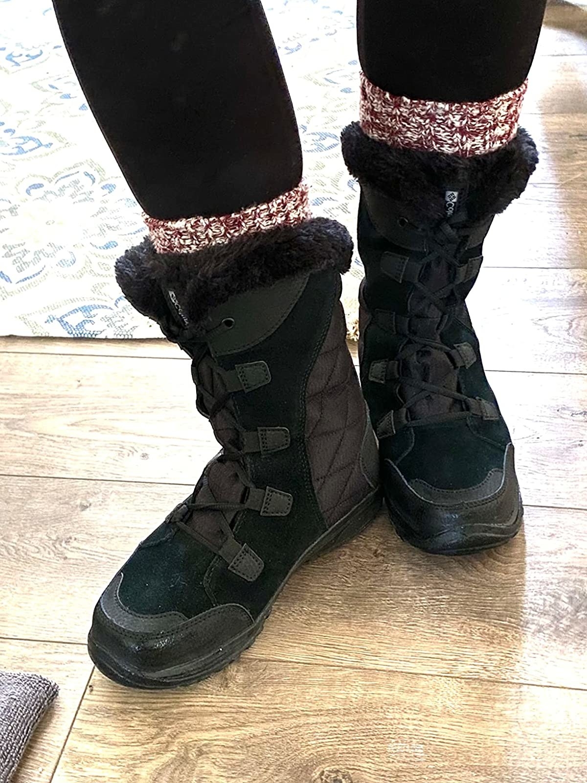 Reviewer wearing back snow boots