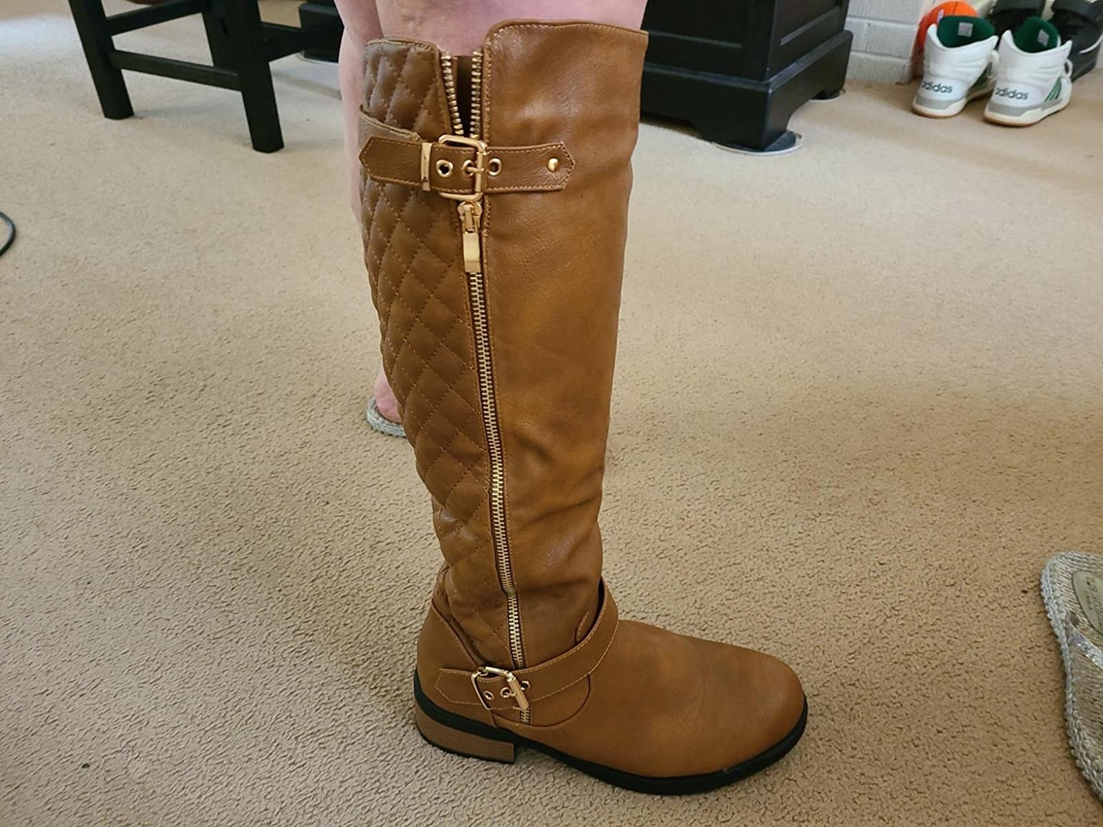 Reviewer wearing brown boot