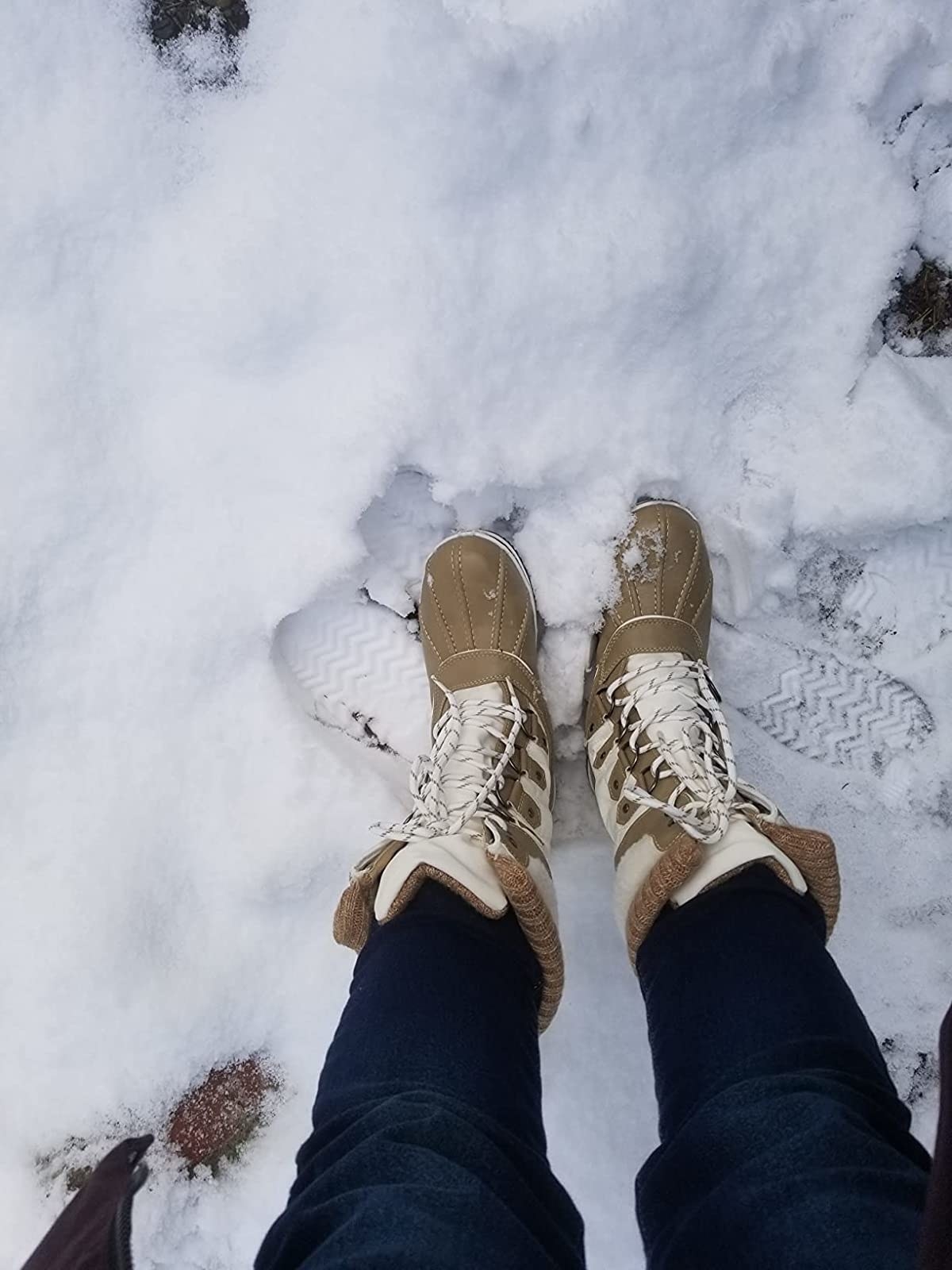 Reviewer wearing boots in the snow