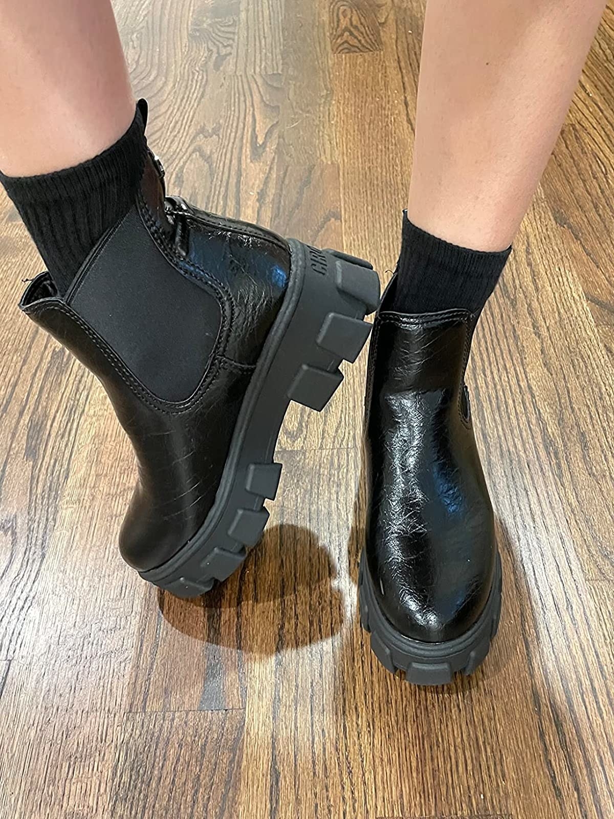 Reviewer wearing black platform boots