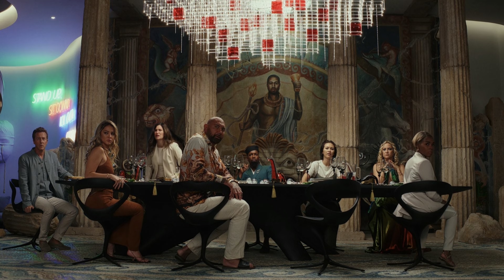 The whole cast sits around a dining table sans Daniel Craig