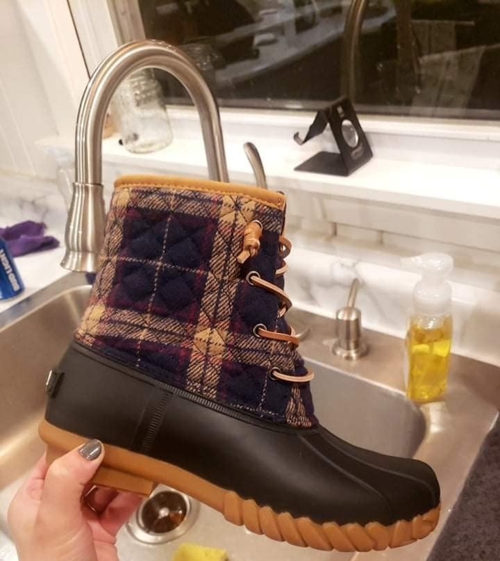 Reviewer holding duck boot