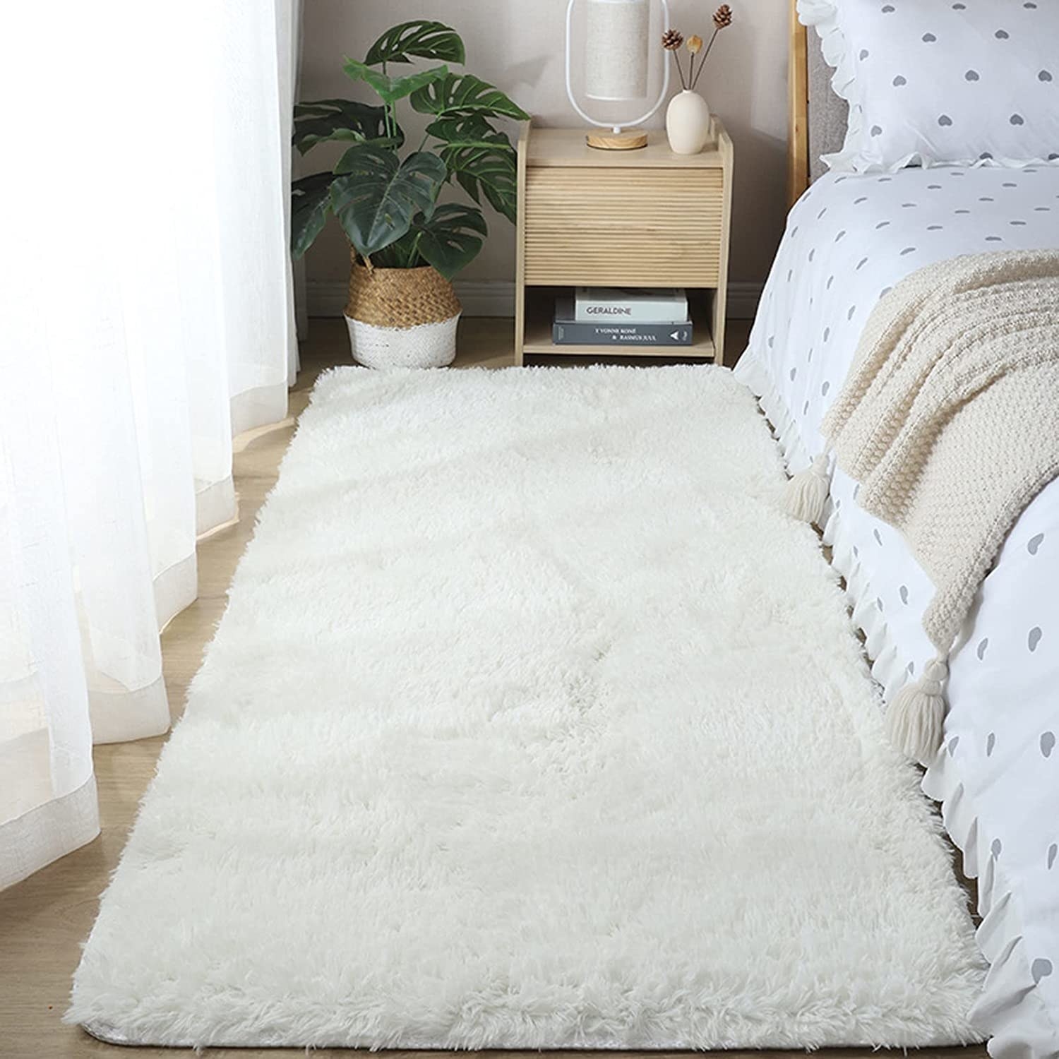 the rug in a bedroom beside a bed and nightstand