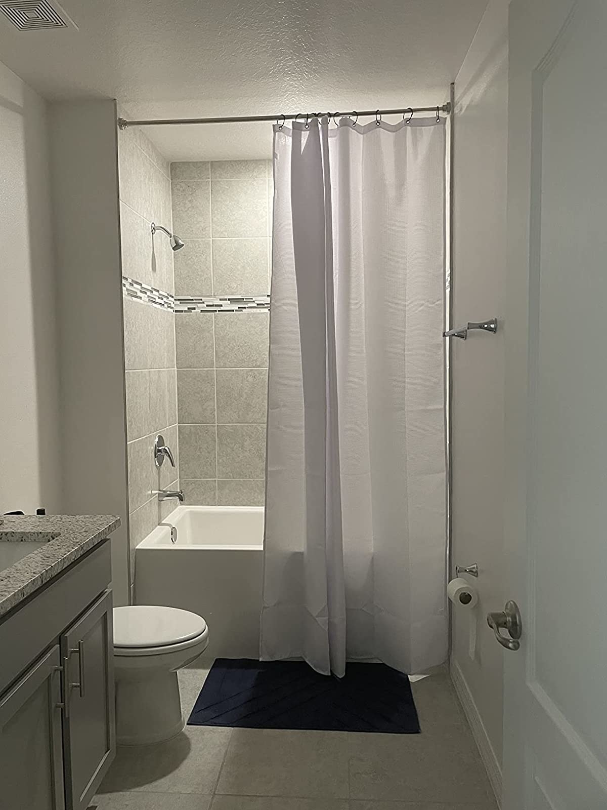 Reviewer image of white shower curtain hanging in their bathroom
