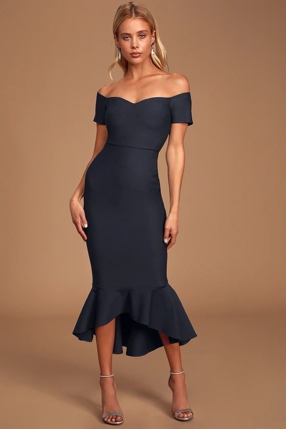 The model wearing the navy dress