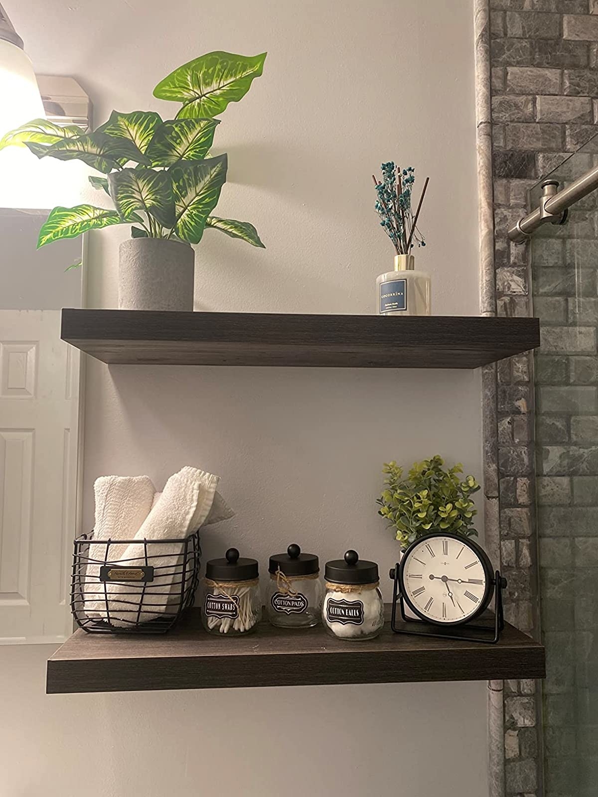 Reviewer image of two floating shelves in their bathroom