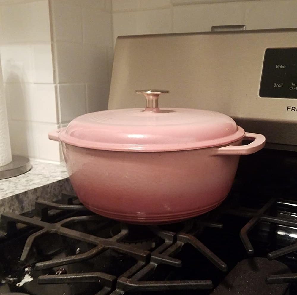 Reviewer image of the pink Dutch oven on a stove