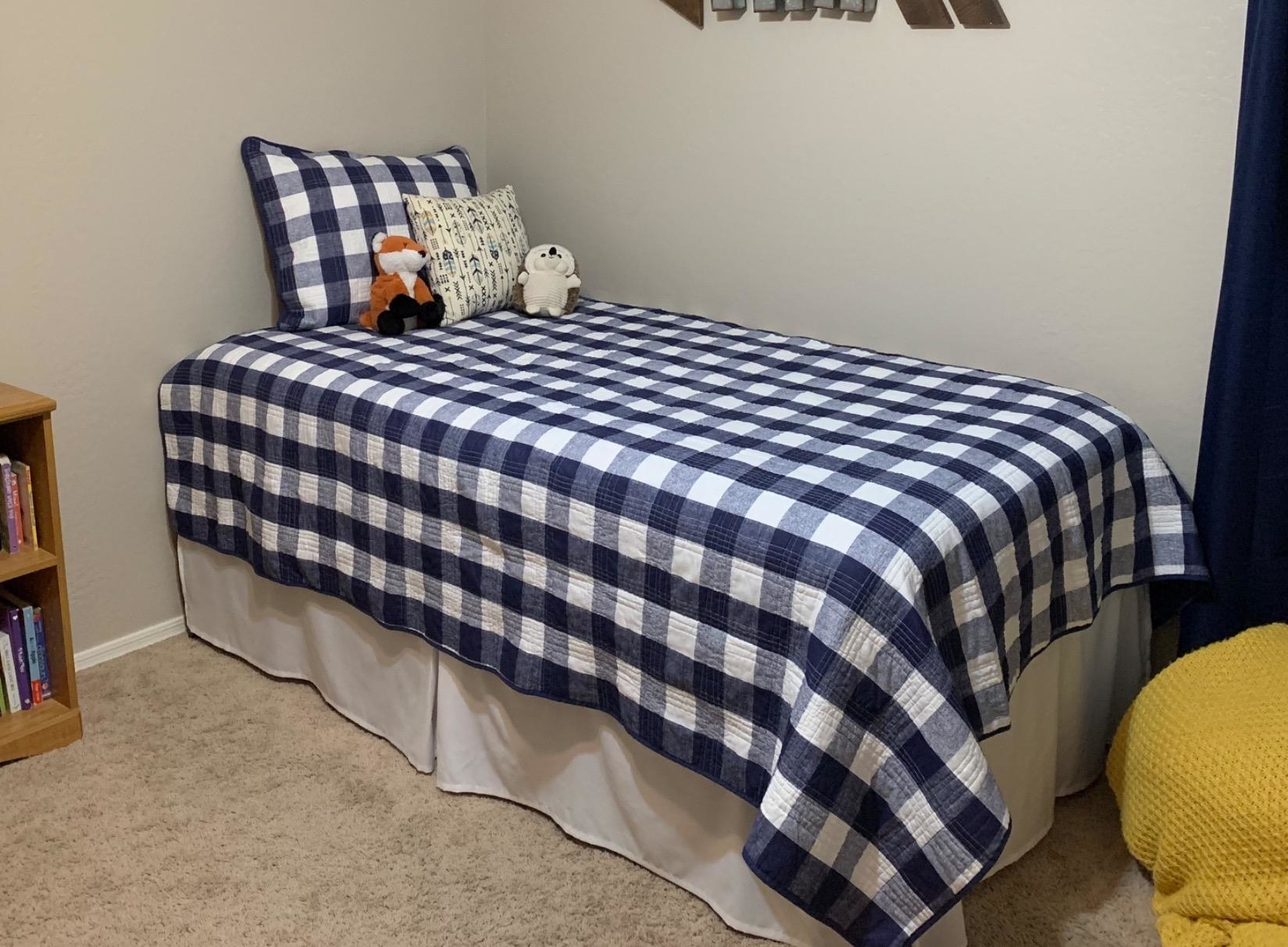 Reviewer image of white bed skirt on a twin bed