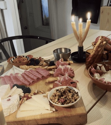 charcuterie board with candle lit