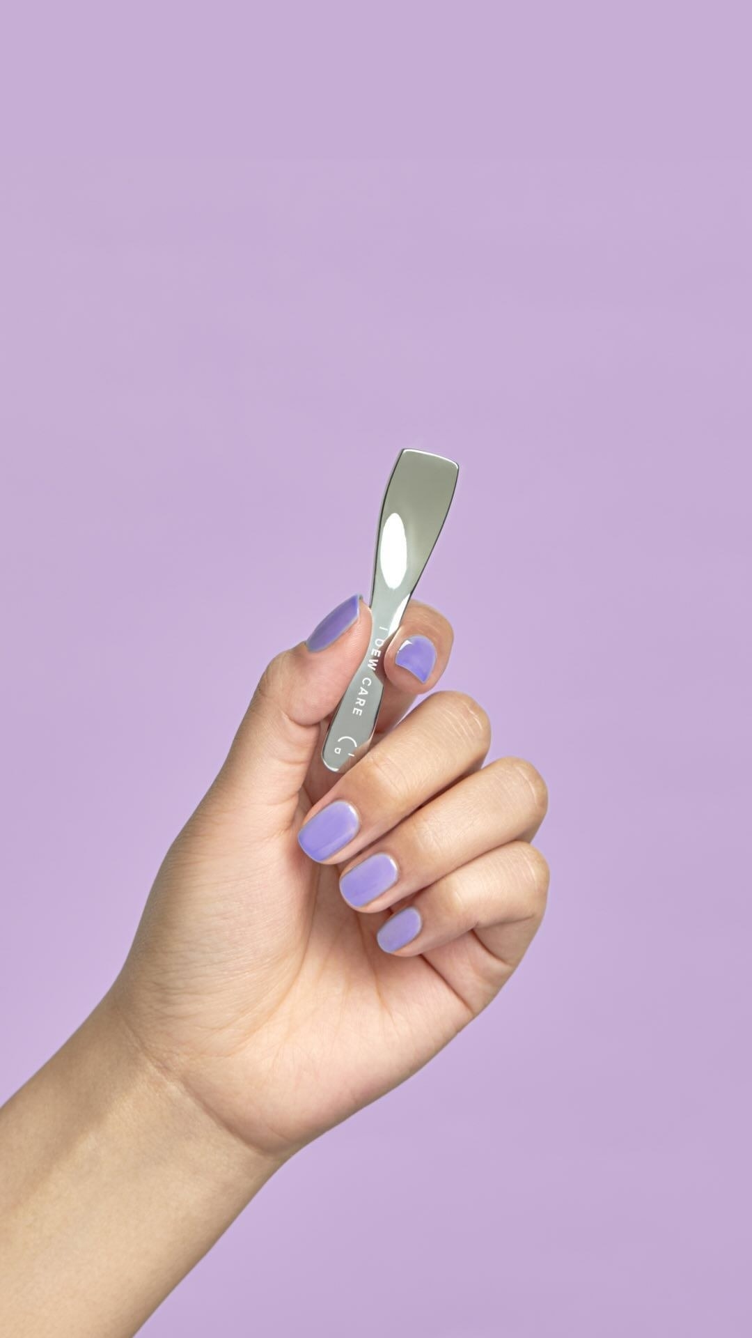 a person holding up the stainless steel beauty scoop