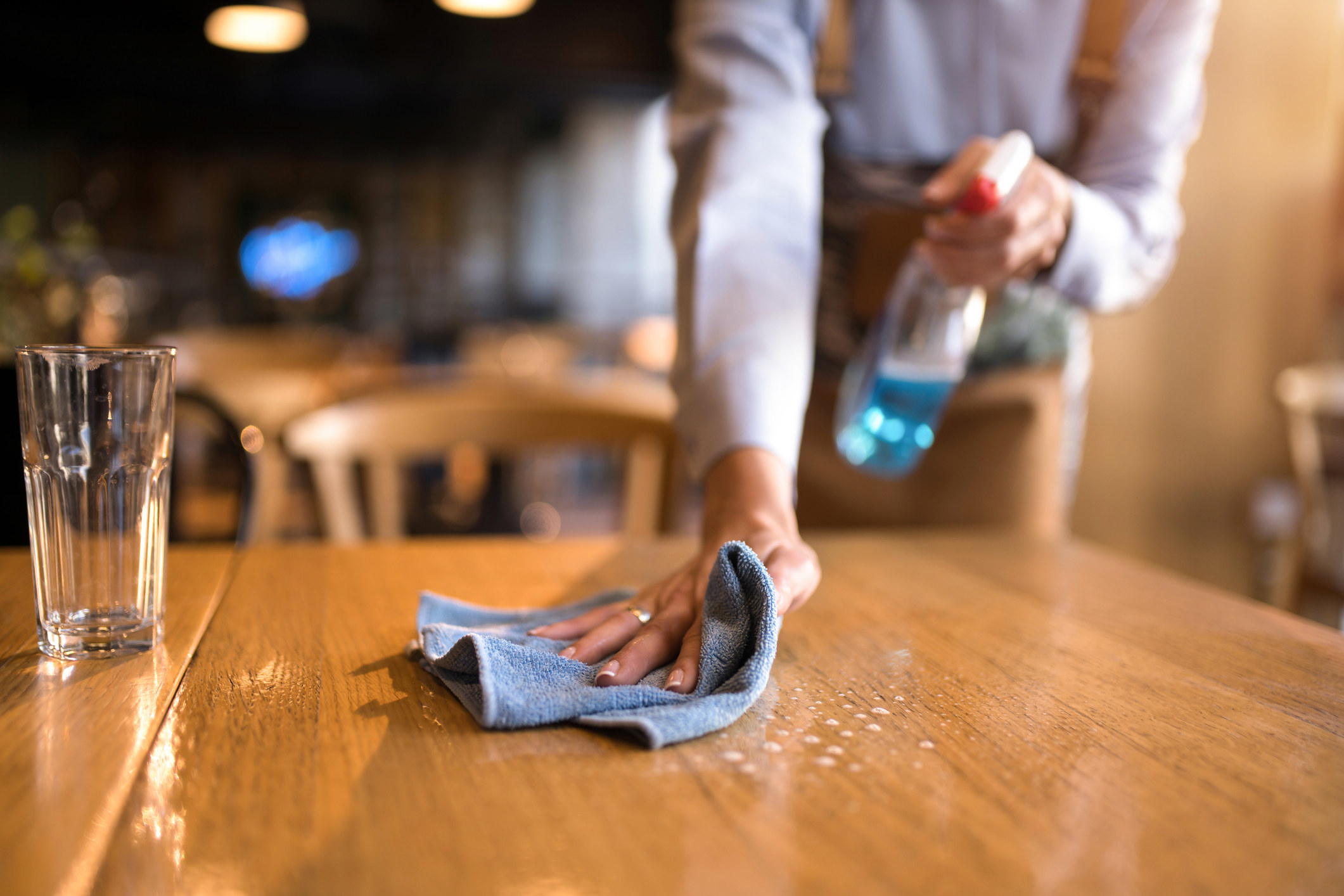 A server cleaning a table