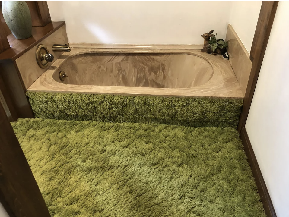 carpet that looks like grass covering the bathroom floor