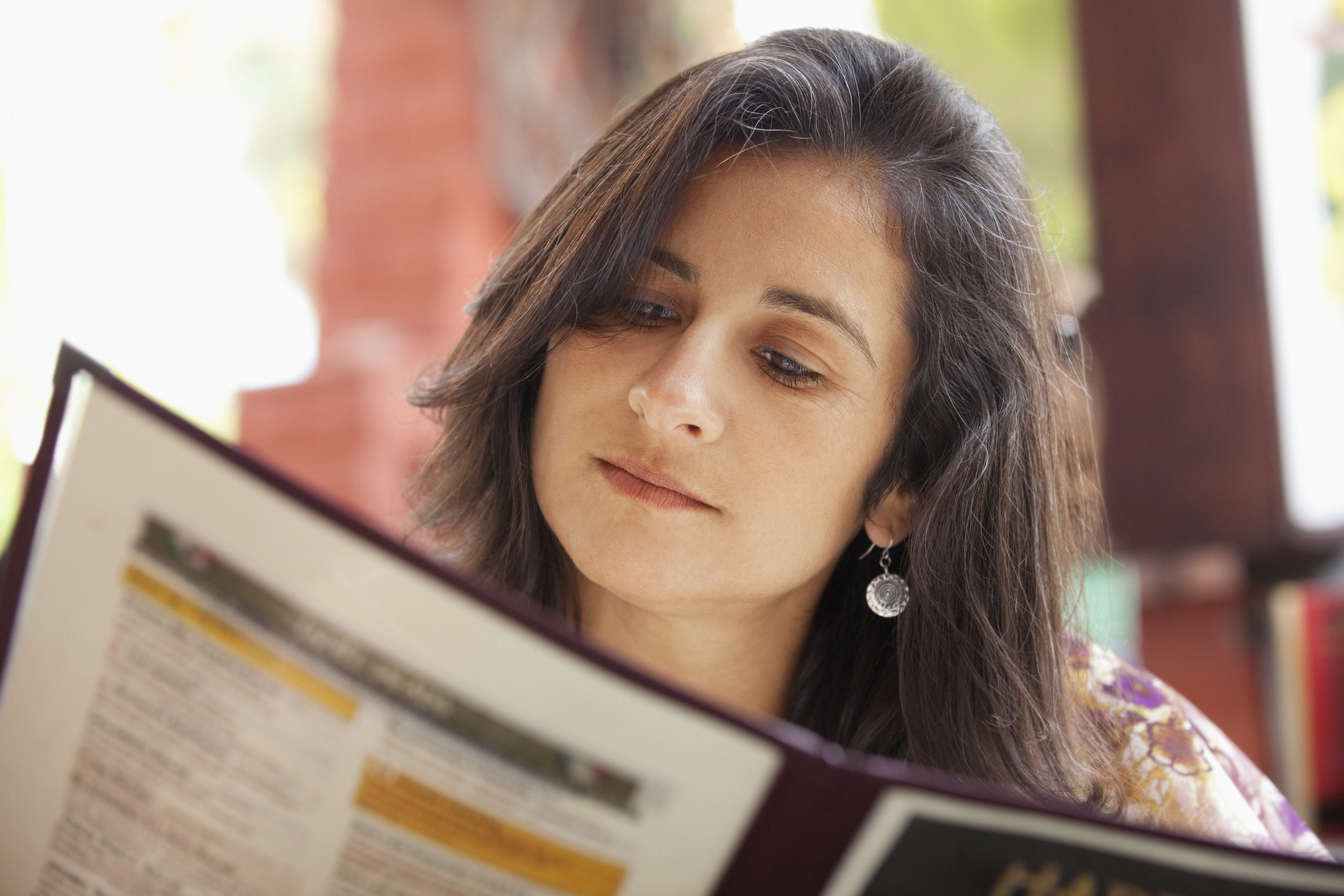 A woman looking at a menu