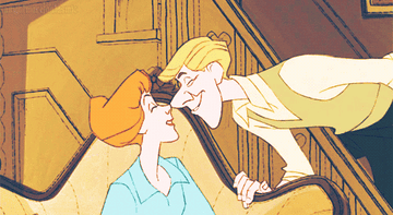 a gif of roger and anita nuzzling from 101 dalmatians