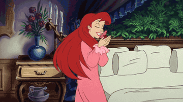 Ariel in pajamas twirling and happily kissing Sebastian