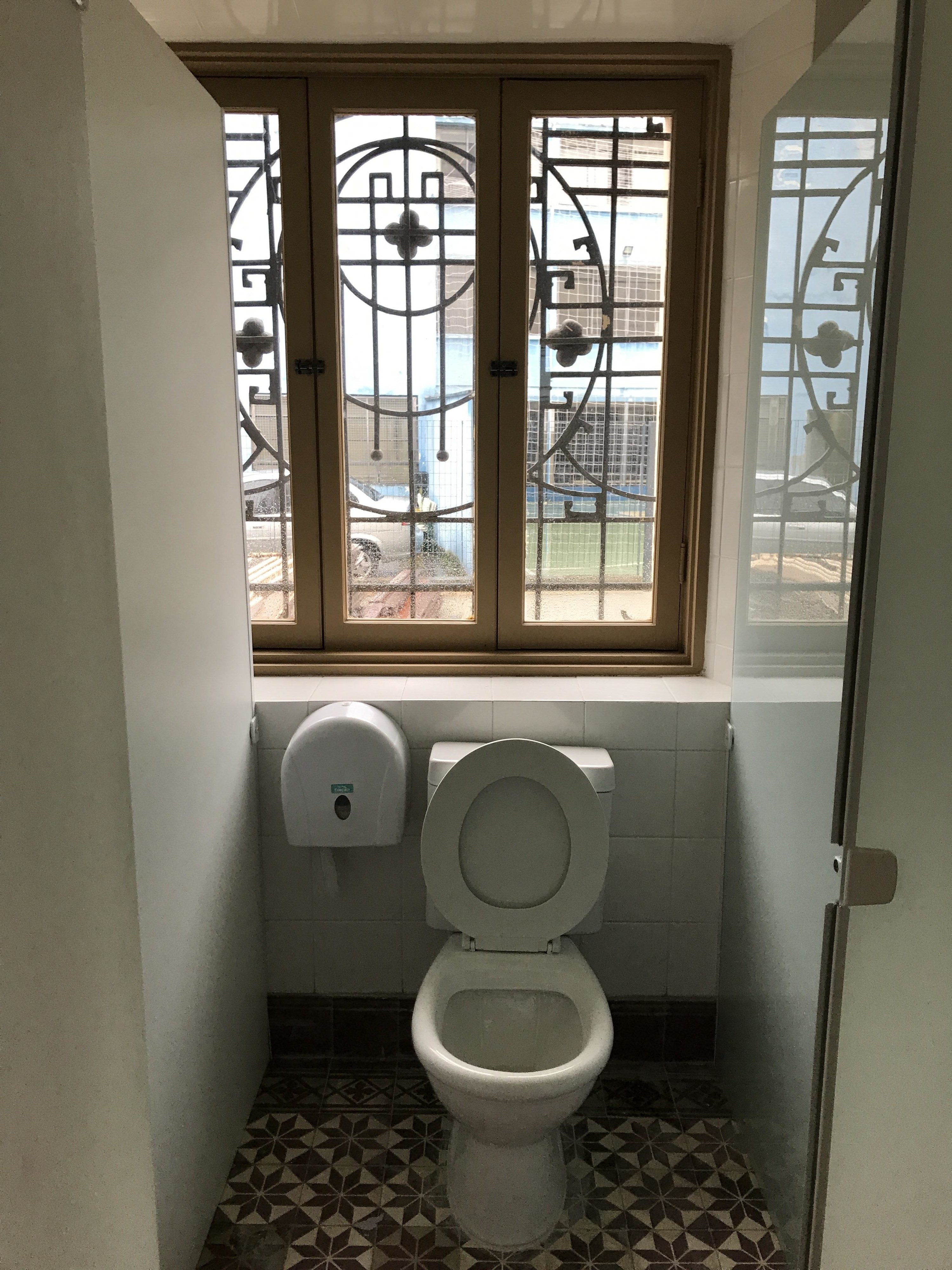 a toilet next to a window