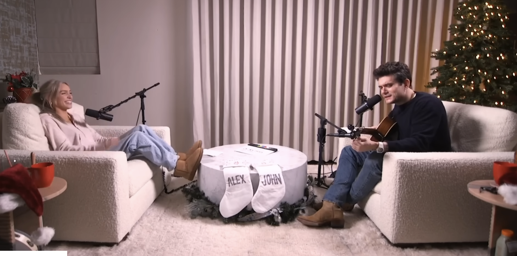 John Mayer playing guitar and singing to someone