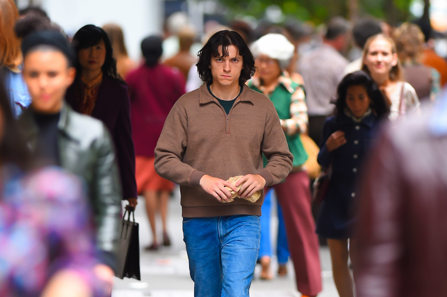 man walking down the street in a crowd of people