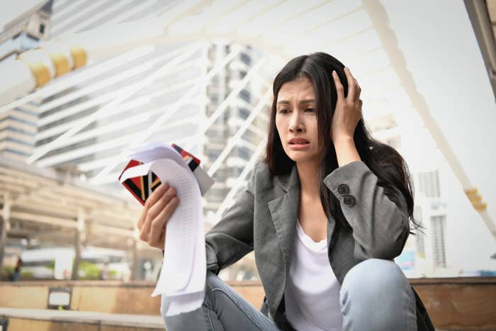 stressed out woman looking at receipts