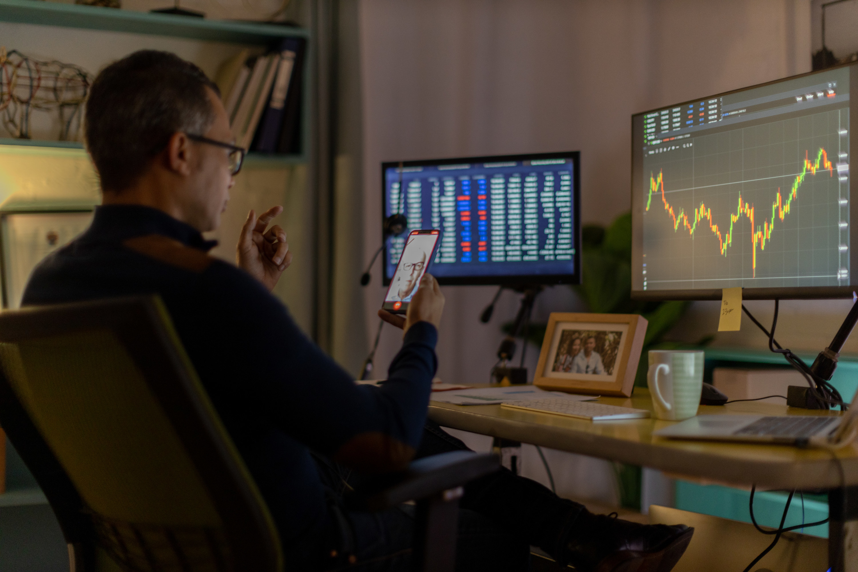 Man reviewing stock performance at home