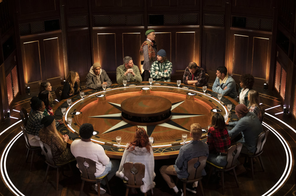 Contestants sit at the round table