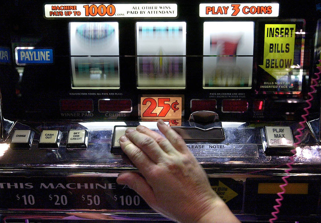 Someone using a slot machine