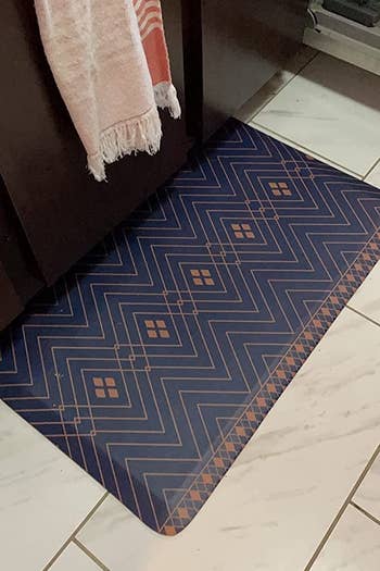 the blue and orange rug sitting on a reviewer's kitchen floor