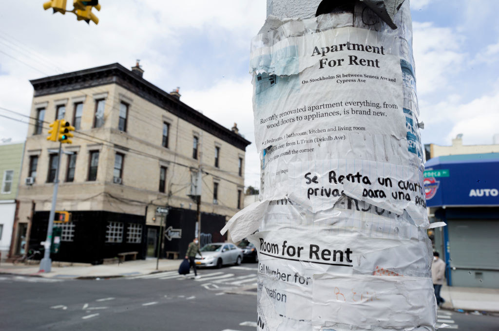 apartment for rent paper postings on street corner in new york