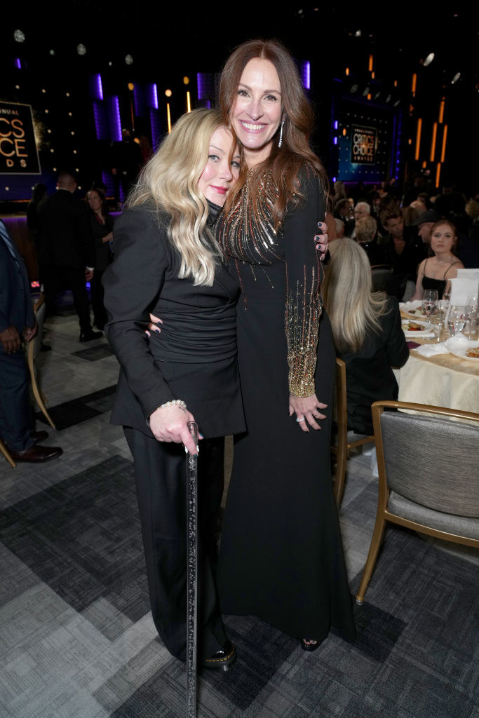 Christina hugging Julia Roberts as they pose for a photograph