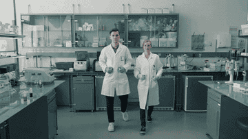 scientists approaching with lab syringes