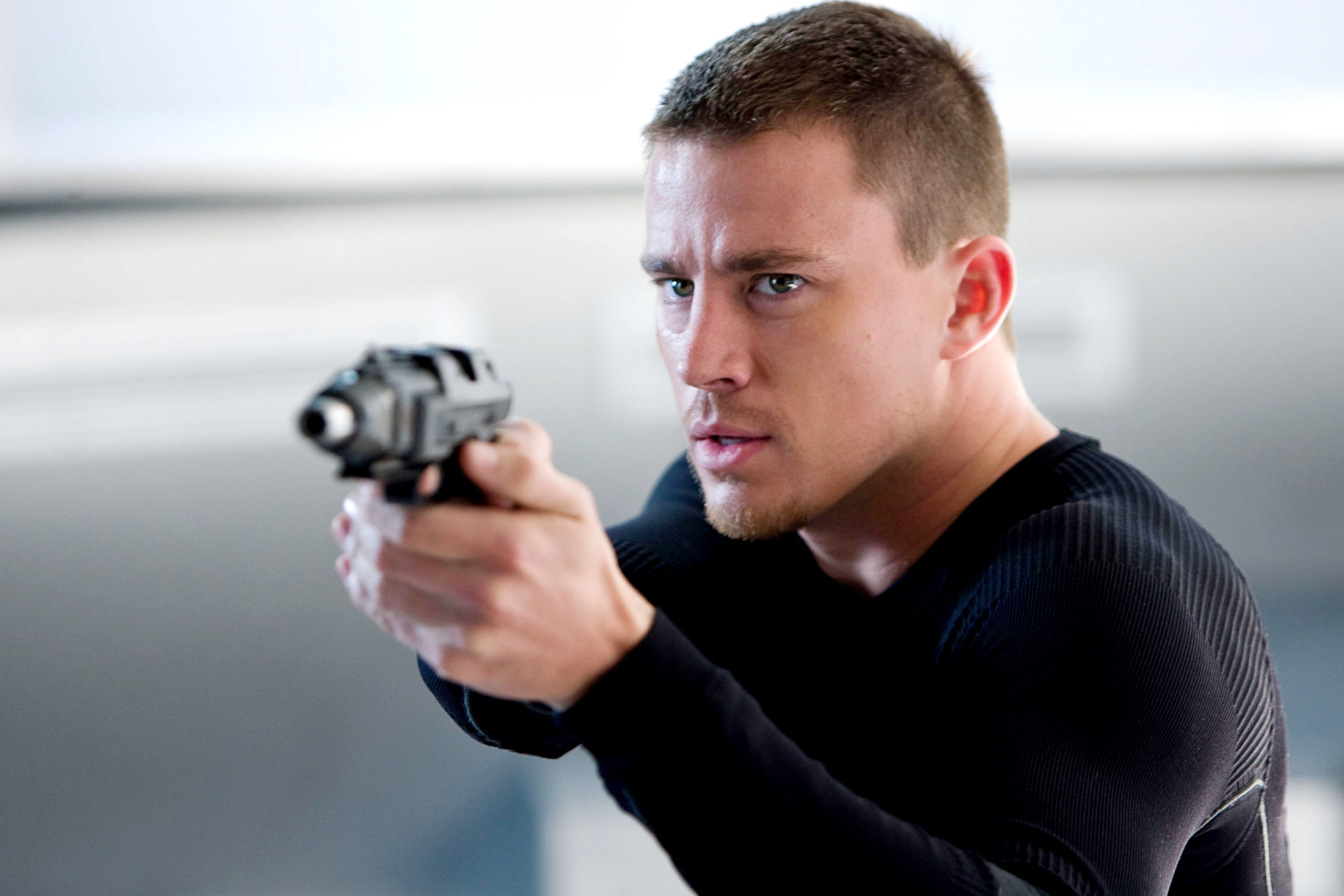 Channing holds a gun in the movie