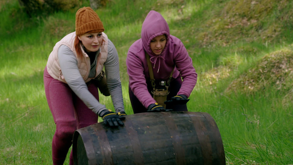 Rachel and Anjelica push a barrell