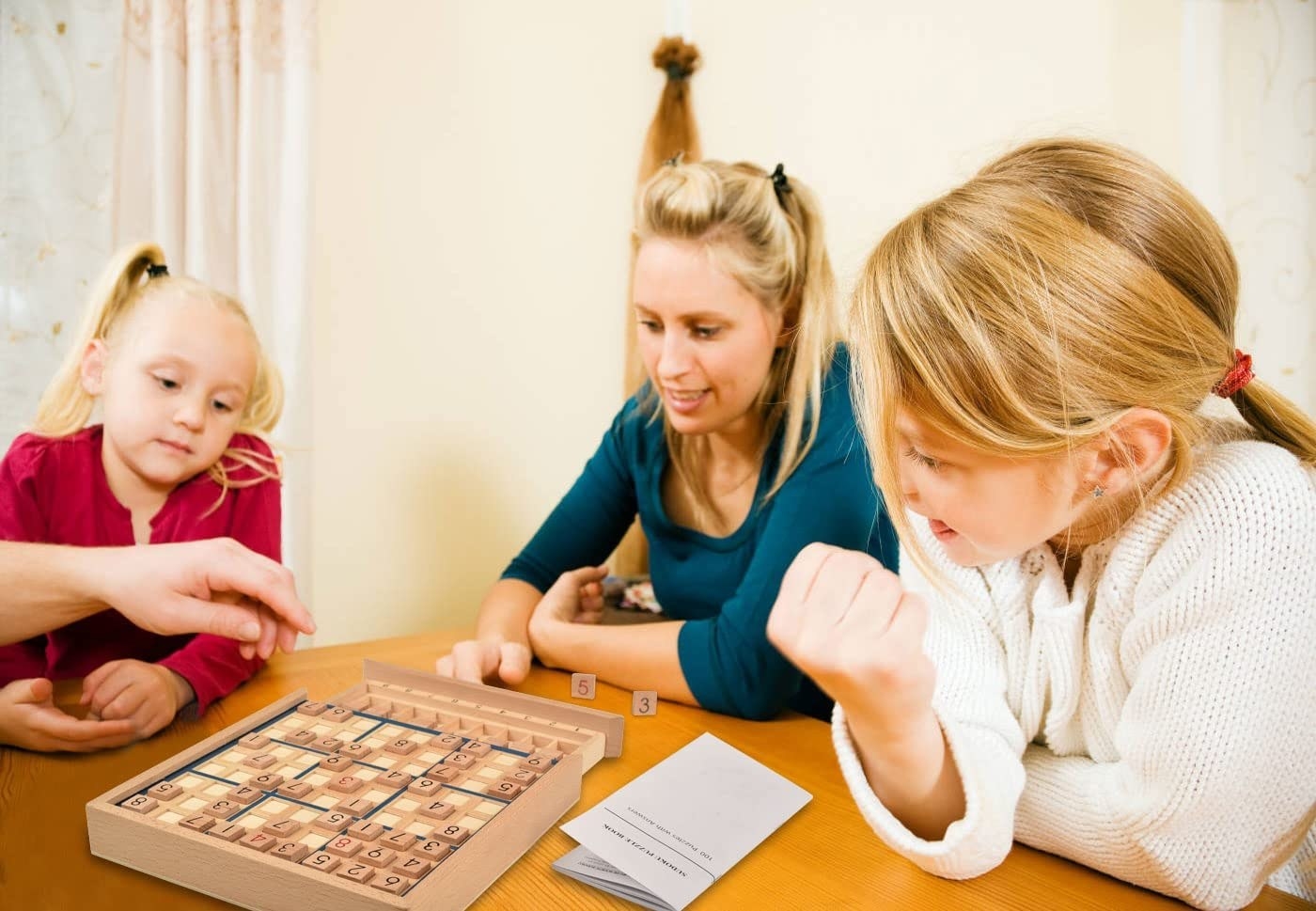 three people playing sudoku