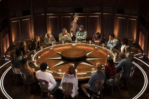 The cast sits around the Round Table
