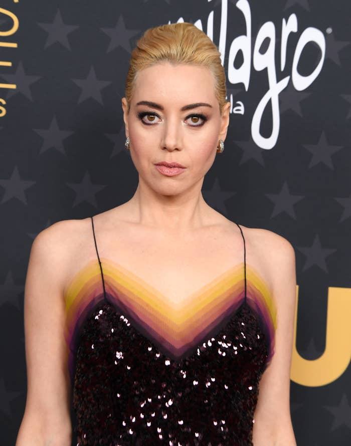 A close-up of Aubrey in a sequined spaghetti-strap dress and her hair pulled back into a sleek updo