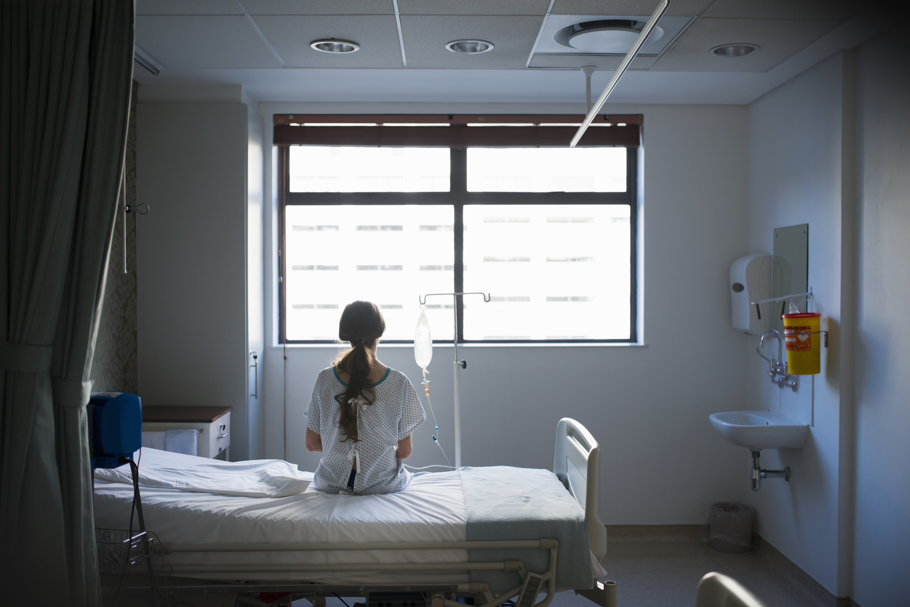 Woman sitting on a bed in the hospital