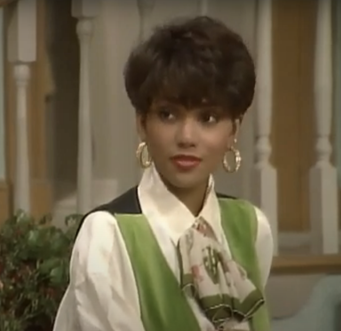 closeup of a younger halle with gold hoop earrings