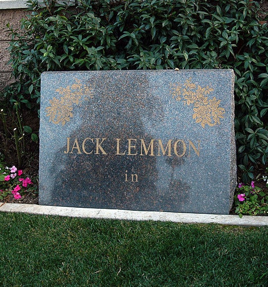 A simple stone marker with Lemmon&#x27;s name and the word &quot;in&quot; below it over a plot of grass