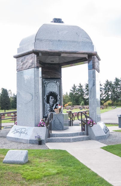 A temple-like tombstone structure engraved with an image of hendrix