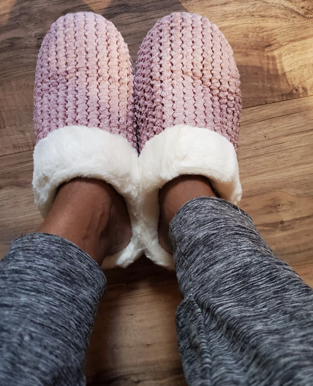 reviewer&#x27;s picture of the slippers in pink