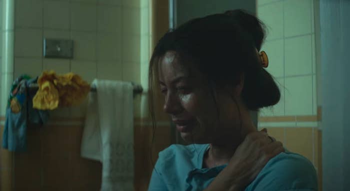 Woman sitting in a bathroom and crying