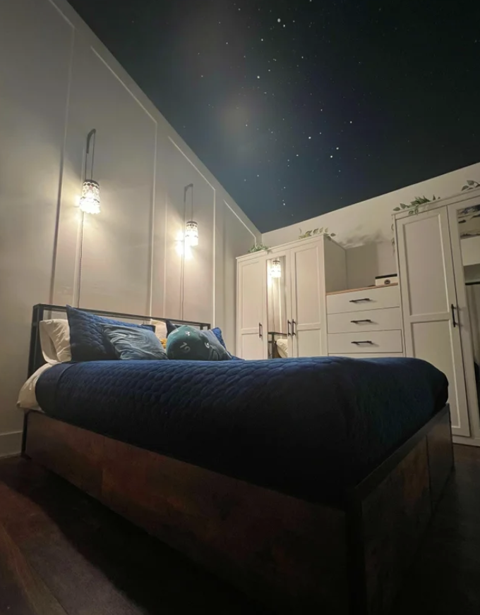 A bedroom with stars on the ceiling