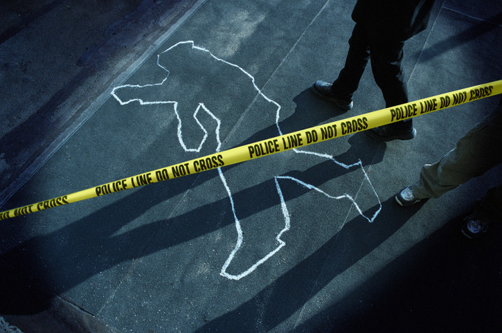 Chalk outline of a body surrounded by police tape