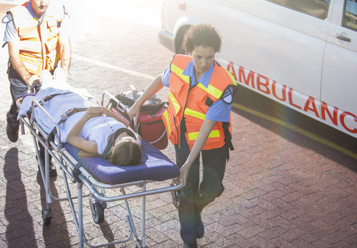 Paramedics with a patient on a gurney