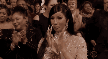 cardi b clapping in the audience at the grammy awards
