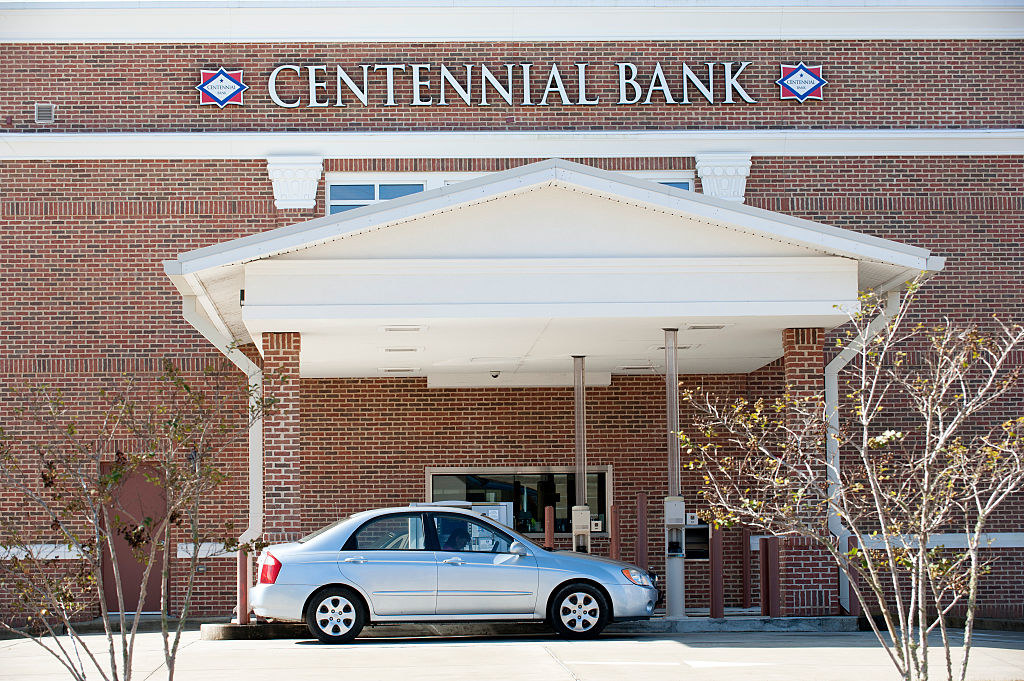 Centennial Bank building facade with drive-thru and a car present