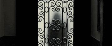 A man in a mask approaches a frosted door