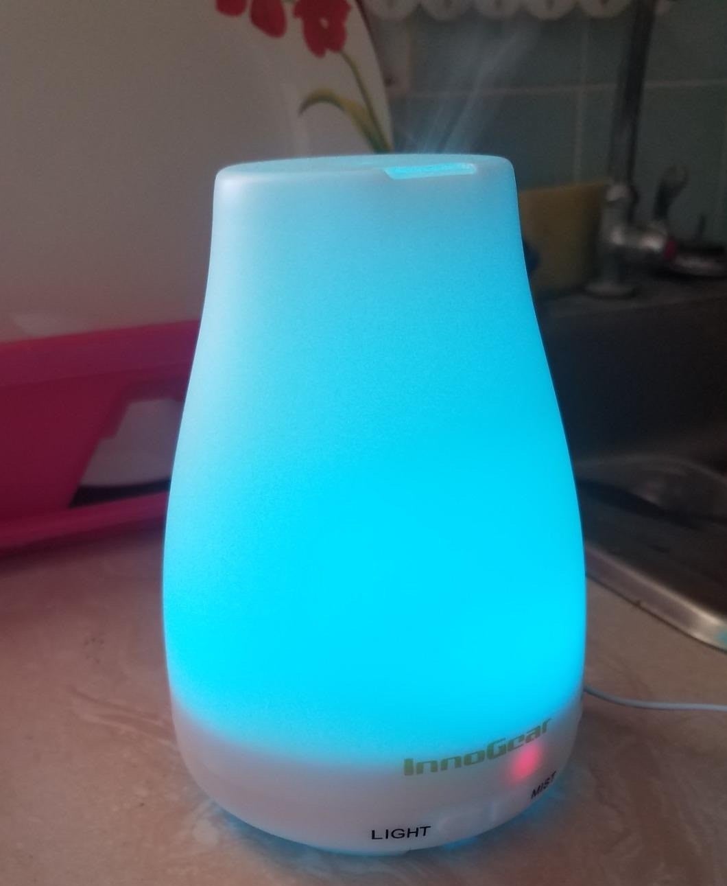 a reviewer photo of the diffuser lit up in blue