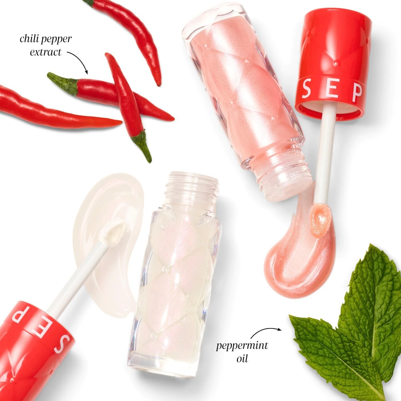 both shades of the lip glosses open with swatches beside peppermint leaves and chili peppers