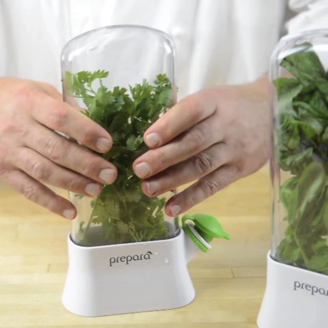 someone lifting one of the herb preserver pods